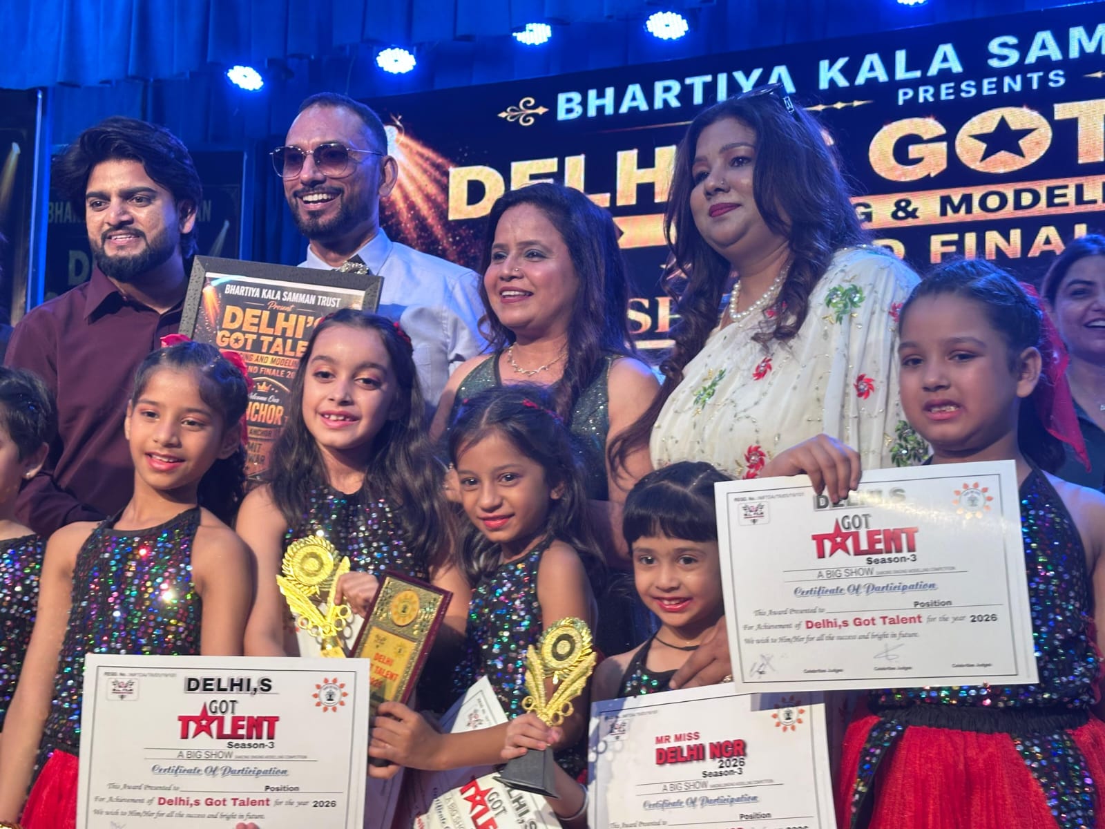 Conferring trophies and certificates to young children on stage