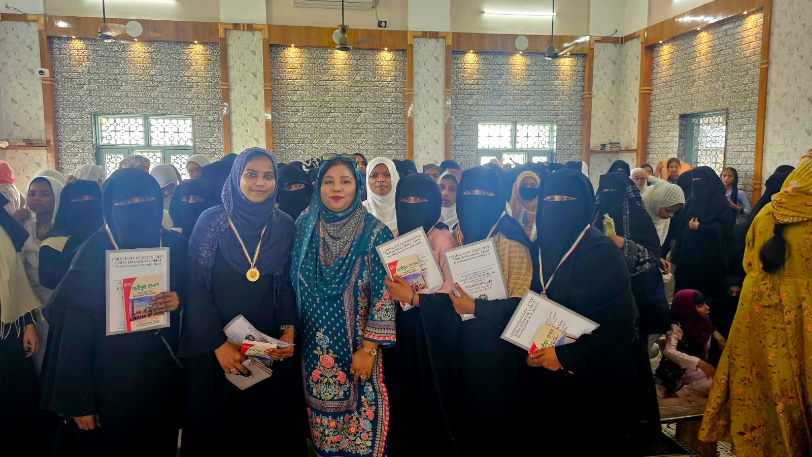 Adv. Qazi with dozens of female diploma recipients and course completion certificates