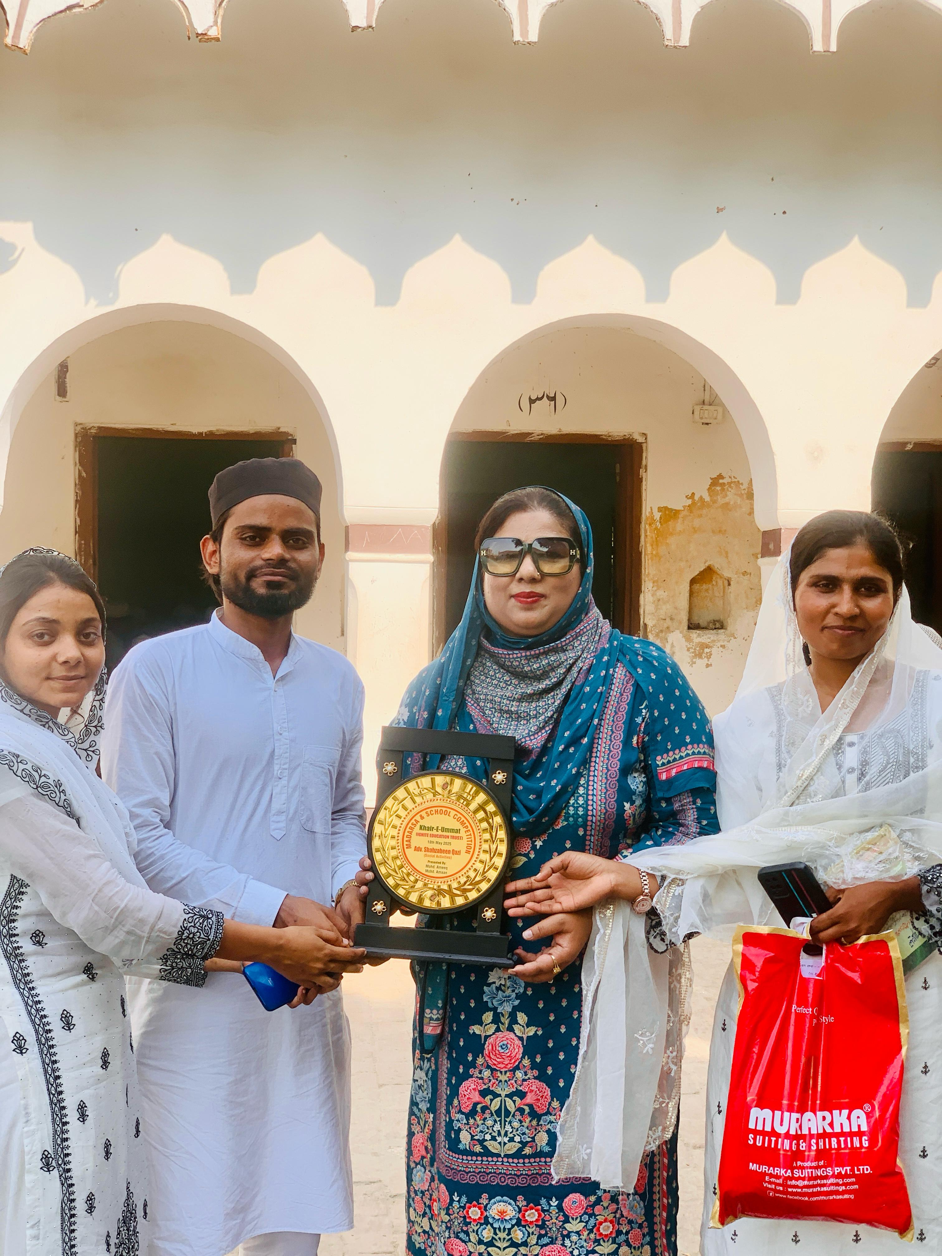 Presenting the Golden Memento plaque to Adv. Shahjabeen Qazi