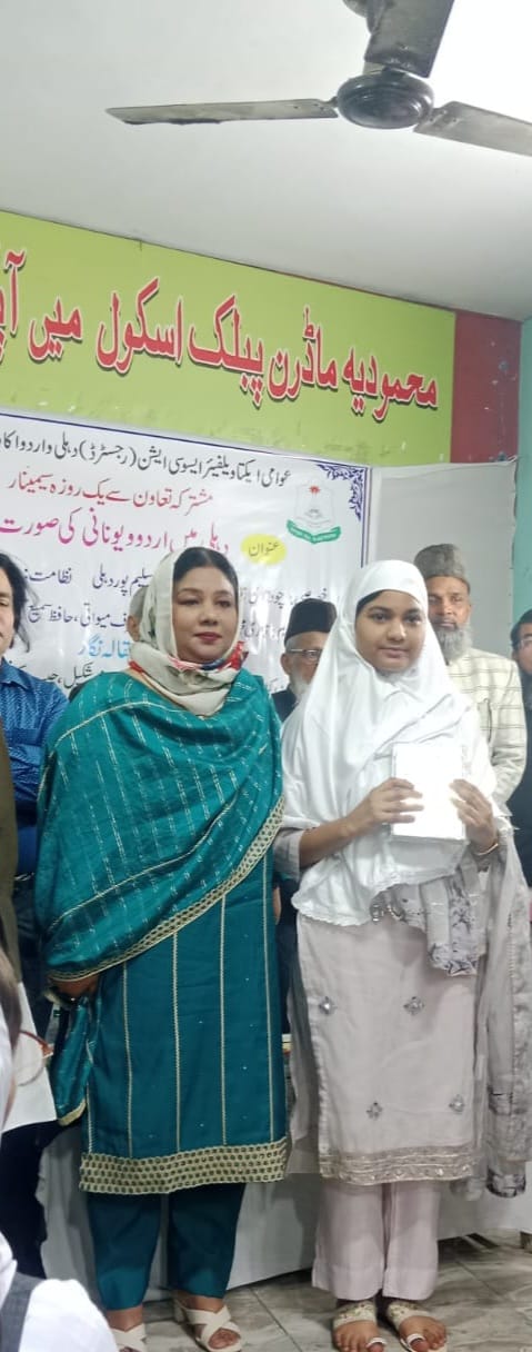 Advocate Shahjabeen Qazi presenting scholastic awards to young girl students